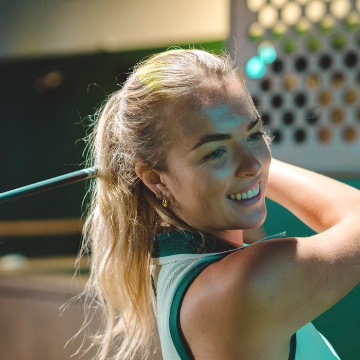 Issi smiling at the finish of her swing